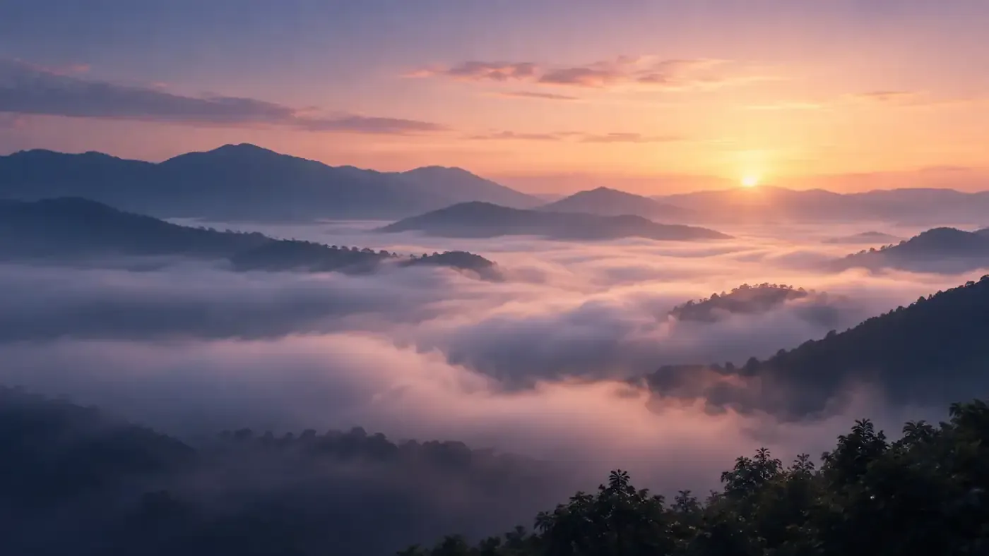 Dawn light over misty mountain landscape